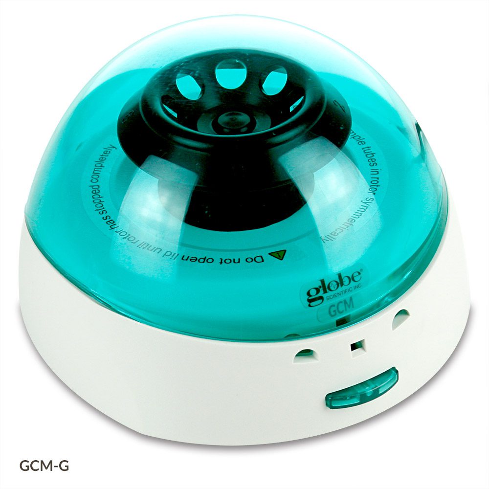A green and white humidifier sitting on top of a table.