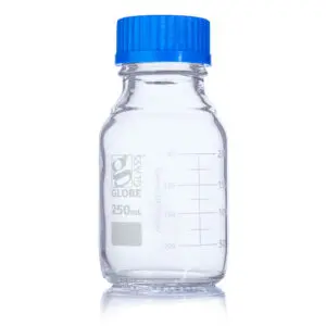 A bottle with blue cap sitting on top of a table.